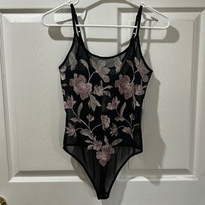 Sheer black & floral thong bodysuit. Never worn. Tags still attached. Size XS.